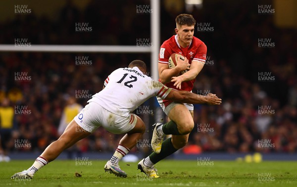 250223 - Wales v England - Guinness Six Nations 2023 - Joe Hawkins of Wales is tackled by Ollie Lawrence of England