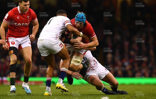 250223 - Wales v England - Guinness Six Nations 2023 - Justin Tipuric of Wales is tackled by Anthony Watson and Owen Farrell of England