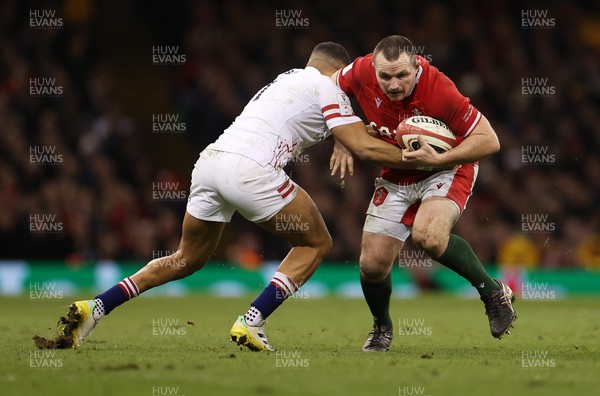 250223 - Wales v England - Guinness 6 Nations - Ken Owens of Wales is tackled by Anthony Watson of England