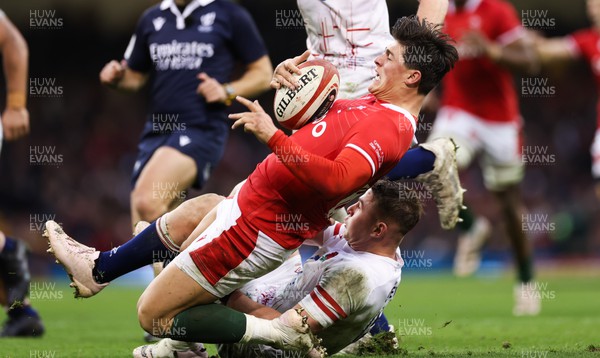 250223 - Wales v England, Guinness Six Nations 2023 - Louis Rees-Zammit of Wales is tackled by Freddie Steward of England