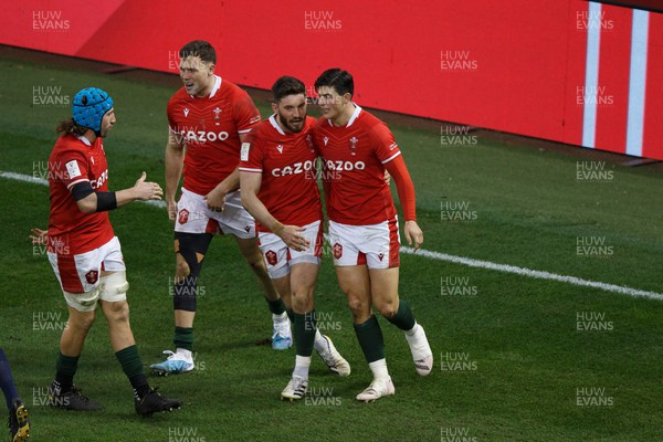 250223 - Wales v England - Guinness Six Nations - Louis Rees-Zammit of Wales celebrates with Owen Williams after scoring a try