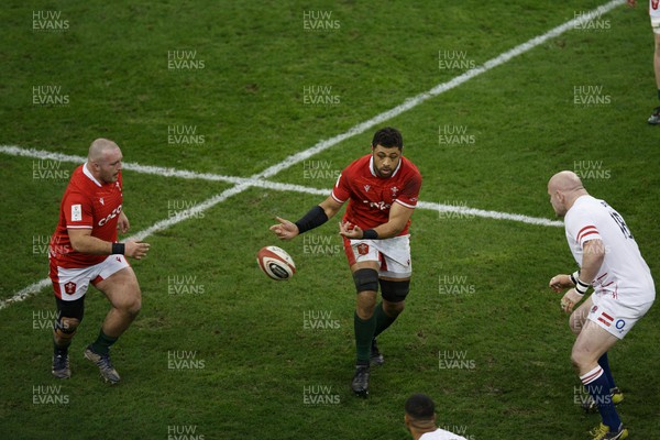 250223 - Wales v England - Guinness Six Nations - Taulupe Faletau of Wales offloads the ball to Dillon Lewis of Wales
