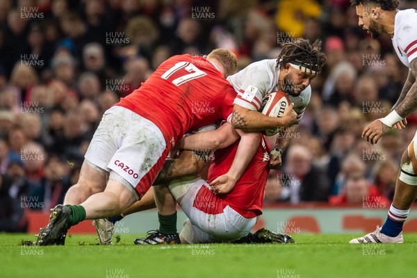 250223 - Wales v England - Guinness Six Nations - Lewis Ludlam of England is tackled by Rhys Carre of Wales