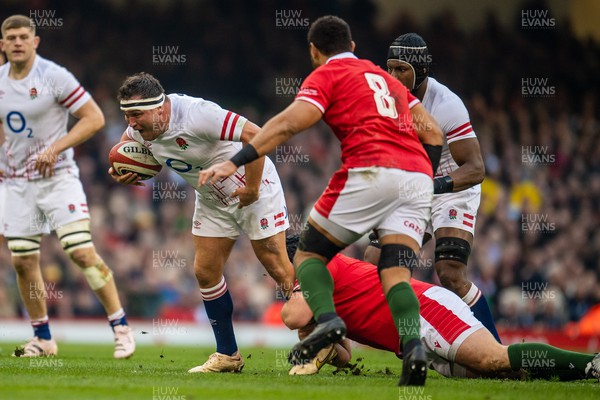 250223 - Wales v England - Guinness Six Nations - Jamie George of England is tackled by Tomas Francis of Wales