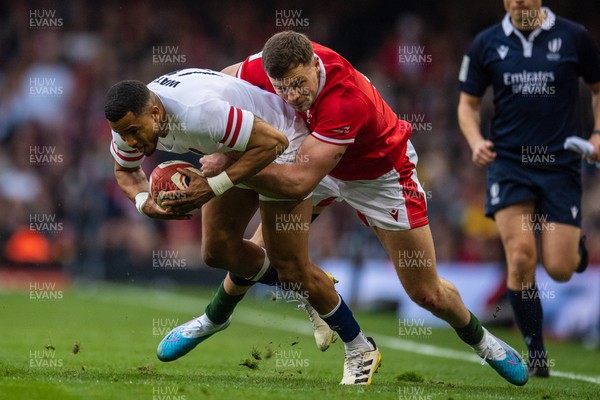 250223 - Wales v England - Guinness Six Nations - Anthony Watson of England is tackled by Mason Grady of Wales