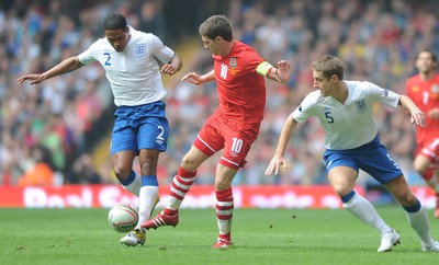 26.03.11 - Wales v England - Euro 2012 Qualifier - Aaron Ramsey of Wales takes on Michael Dawson and Glen Johnson of England. 