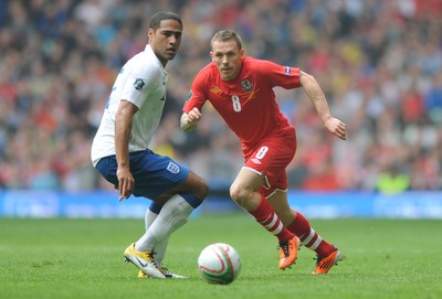 26.03.11 - Wales v England - Euro 2012 Qualifier - Craig Bellamy of Wales gets the ball past Glen Johnson of England. 