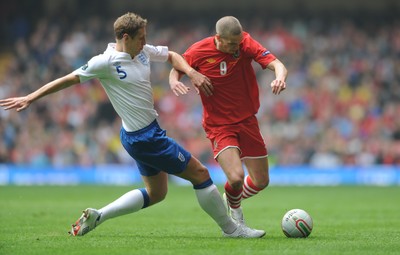 26.03.11 - Wales v England - Euro 2012 Qualifier - Steve Morison of Wales is tackled by Michael Dawson of England. 