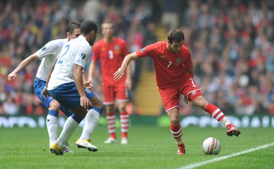 26.03.11 - Wales v England - Euro 2012 Qualifier - Joe Ledley of Wales is tackled by Glen Johnson of England. 