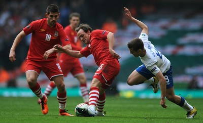 26.03.11 - Wales v England - Euro 2012 Qualifier - David Vaughan of Wales is tackled by Jack Wilshere of England. 