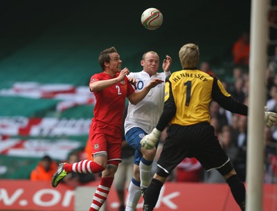 26.03.11 - Wales v England, UEFA Euro 2012 Qualifier -  England's Wayne Rooney puts Wales' Chris Gunter and Wales' keeper Wayne Hennessey under pressure 