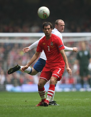 26.03.11 - Wales v England, UEFA Euro 2012 Qualifier -  Wales' Joe Ledley  gets the better of England's Wayne Rooney  