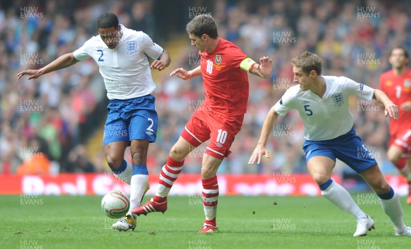 26.03.11 - Wales v England - Euro 2012 Qualifier - Aaron Ramsey of Wales takes on Michael Dawson and Glen Johnson of England. 