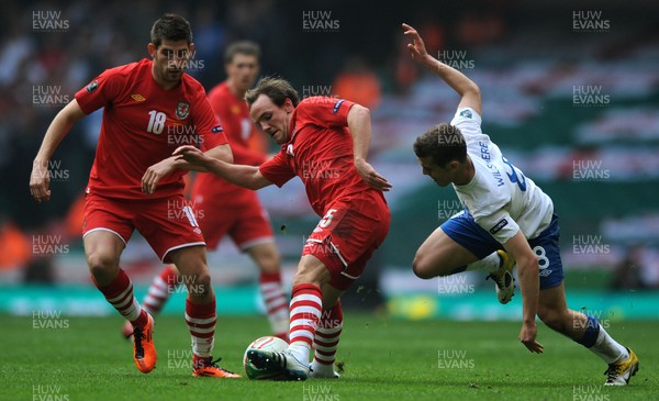 26.03.11 - Wales v England - Euro 2012 Qualifier - David Vaughan of Wales is tackled by Jack Wilshere of England. 