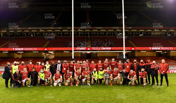 270221 - Wales v England - Guinness Six Nations - Wales squad and management pictured with the triple crown trophy  and 250 Welsh rugby club jerseys at the end of the game