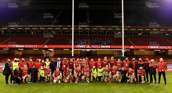 270221 - Wales v England - Guinness Six Nations - Wales squad and management pictured with the triple crown trophy  and 250 Welsh rugby club jerseys at the end of the game