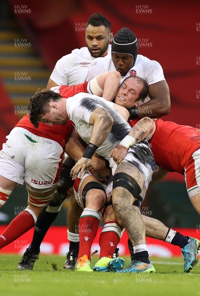 270221 - Wales v England - Guinness 6 Nations - Alun Wyn Jones of Wales is held by Maro Itoje of England