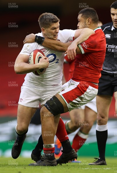 270221 - Wales v England - Guinness 6 Nations - Owen Farrell of England is tackled by Taulupe Faletau of Wales