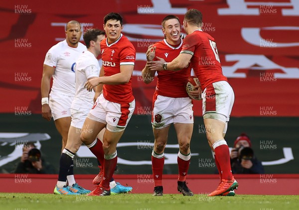 270221 - Wales v England - Guinness 6 Nations - Josh Adams of Wales celebrates scoring a try with Louis Rees-Zammit and George North of Wales