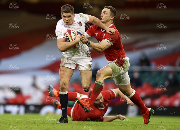 270221 - Wales v England - Guinness 6 Nations - Owen Farrell of England is tackled by George North of Wales