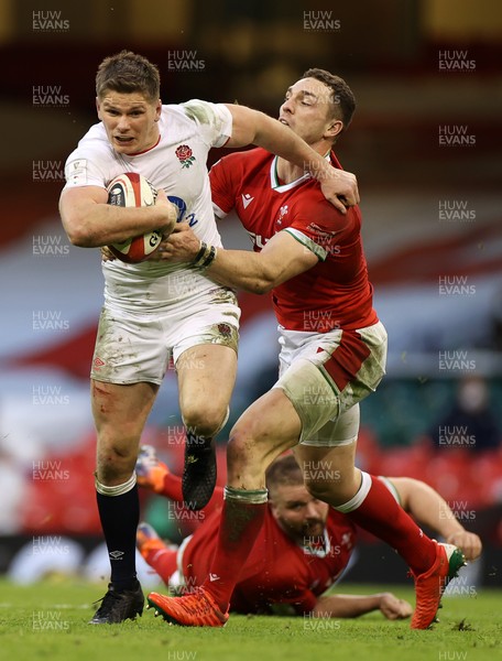 270221 - Wales v England - Guinness 6 Nations - Owen Farrell of England is tackled by George North of Wales
