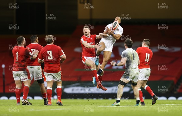 270221 - Wales v England, Guinness 2021 Six Nations Championship - Anthony Watson of England takes the ball as he competes with Dan Biggar of Wales