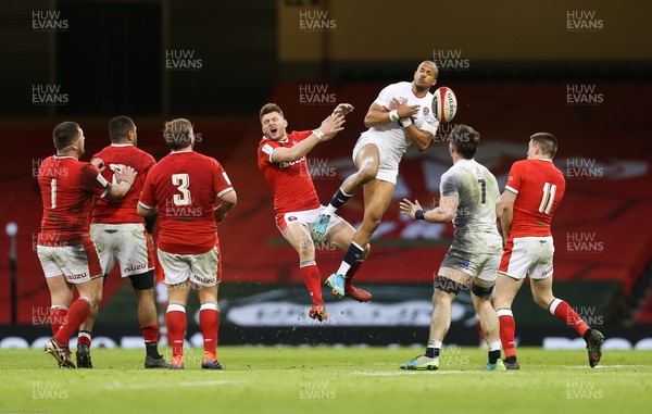 270221 - Wales v England, Guinness 2021 Six Nations Championship - Anthony Watson of England takes the ball as he competes with Dan Biggar of Wales