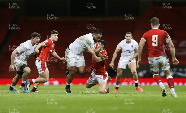 270221 - Wales v England, Guinness 2021 Six Nations Championship - Billy Vunipola of England crashes through the tackle by Louis Rees-Zammit of Wales
