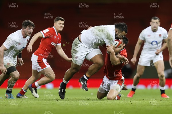 270221 - Wales v England, Guinness 2021 Six Nations Championship - Billy Vunipola of England crashes through the tackle by Louis Rees-Zammit of Wales