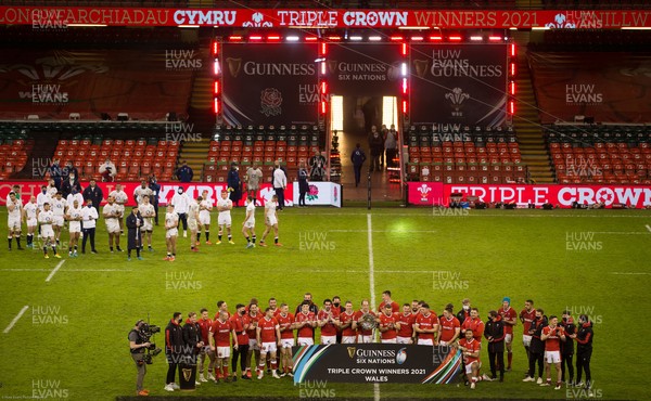 270221 - Wales v England, Guinness 2021 Six Nations Championship - Wales are presented with the Triple Crown as the beaten English team look on