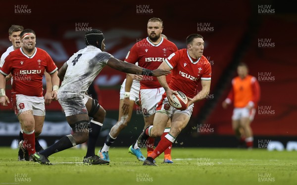 270221 - Wales v England, Guinness 2021 Six Nations Championship - Josh Adams of Wales gets past Maro Itoje of England