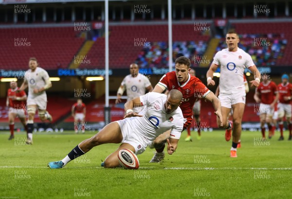270221 - Wales v England, Guinness 2021 Six Nations Championship - Anthony Watson of England beats Kieran Hardy of Wales to the ball to prevent a try