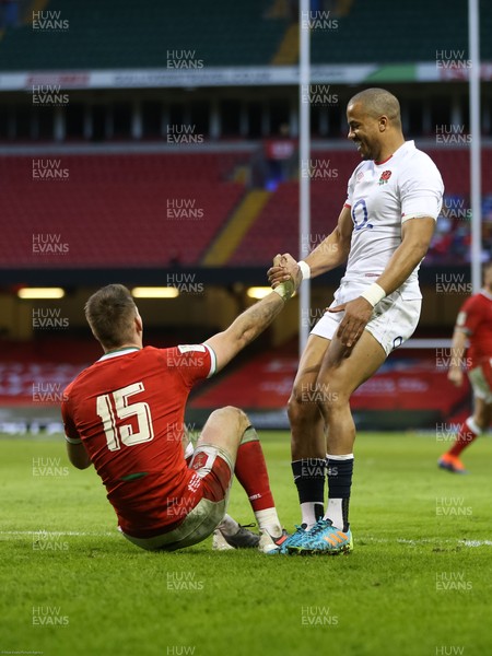 270221 - Wales v England, Guinness 2021 Six Nations Championship - Anthony Watson of England helps Liam Williams of Wales back to his feet after he races through onto the ball to score try