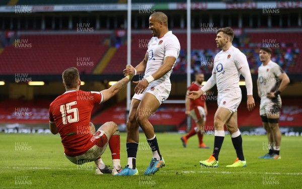 270221 - Wales v England, Guinness 2021 Six Nations Championship - Anthony Watson of England helps Liam Williams of Wales back to his feet after he races through onto the ball to score try