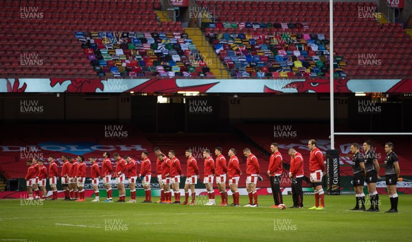 270221 - Wales v England, Guinness 2021 Six Nations Championship - The Welsh team line up for the anthems in front of Welsh rugby club shirts displayed on the middle tier of the south stand