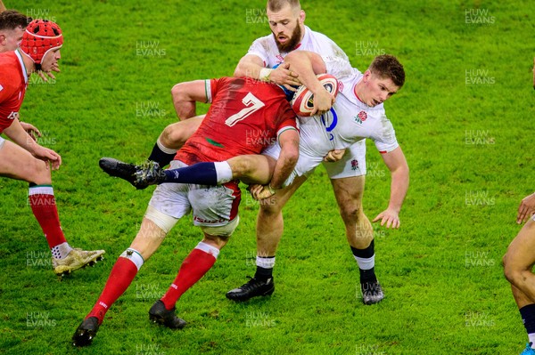 270221 - Wales v England - Guinness Six Nations - Owen Farrell of England is tackled by Justin Tipuric of Wales 