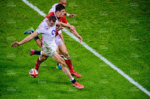 270221 - Wales v England - Guinness Six Nations - Jonny May of England and Louis Rees-Zammit of Wales compete for the loose ball
