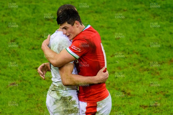270221 - Wales v England - Guinness Six Nations - Louis Rees-Zammit of Wales  and Jonny May of England embrace at the final whistle