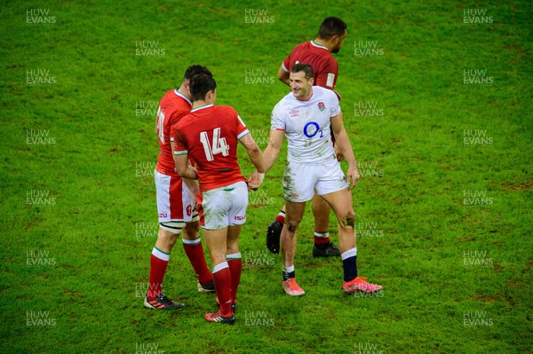 270221 - Wales v England - Guinness Six Nations - Louis Rees-Zammit of Wales  and Jonny May of England embrace at the final whistle