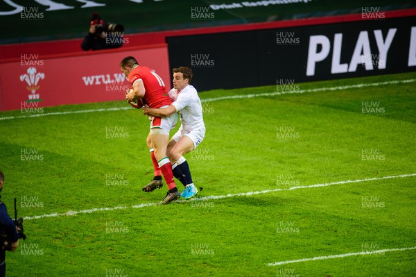 270221 - Wales v England - Guinness Six Nations - Josh Adams of Wales beats George Ford of England  to the high ball to score 