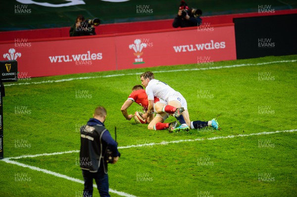 270221 - Wales v England - Guinness Six Nations - Josh Adams of Wales beats George Ford of England  to the high ball to score 