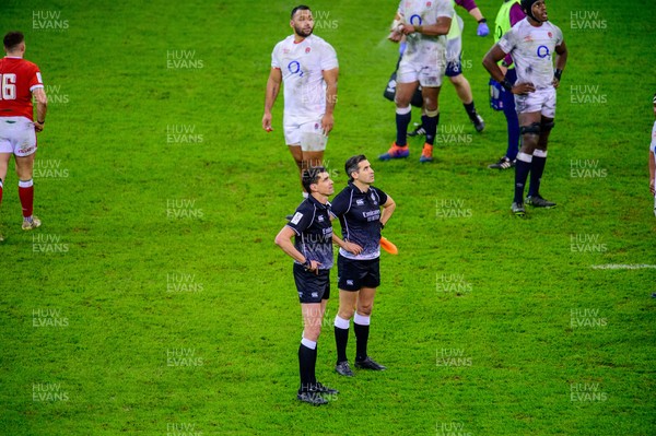 270221 - Wales v England - Guinness Six Nations - Referee Pascal Gauzere  and his linesman watch a tv replay