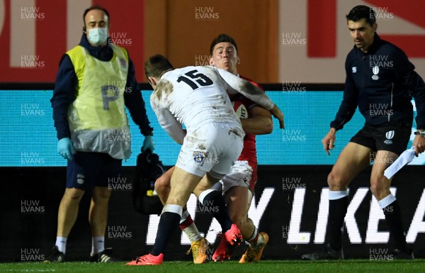 281120 - Wales v England - Autumn Nations Cup - Josh Adams of Wales is tackled by Elliot Daly of England