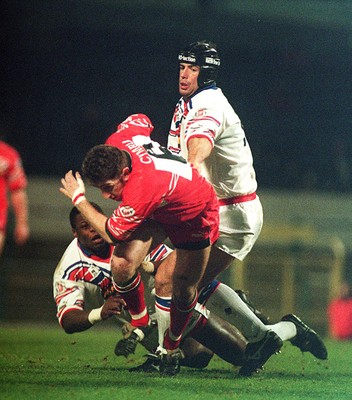 010295 - Wales v England - Rugby League - Jonathan Davies of Wales beats the tackle of Phil Clarke