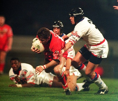 010295 - Wales v England - Rugby League - Jonathan Davies of Wales is tackled by Daryl Powell of England