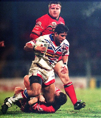 010295 - Wales v England - Rugby League - Ikram Butt of England is tackled by Kevin Ellis of Wales