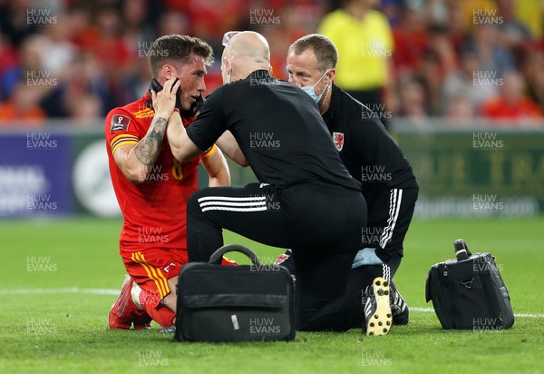 080921 - Wales v Estonia, World Cup 2022 Qualifying - Harry Wilson of Wales is looked at by medics after colliding the Estonia goalkeeper Karl Hein in the penalty box