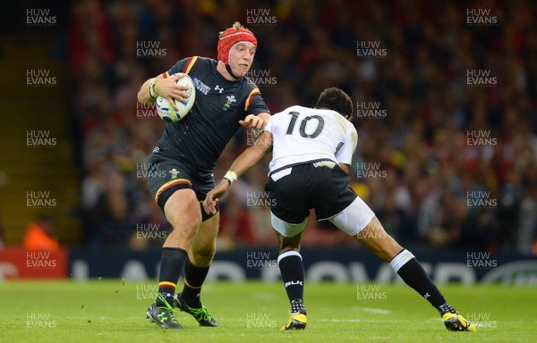 011015 - Wales v Fiji - Rugby World Cup 2015 -Tyler Morgan of Wales is tackled by Ben Volavola of Fiji