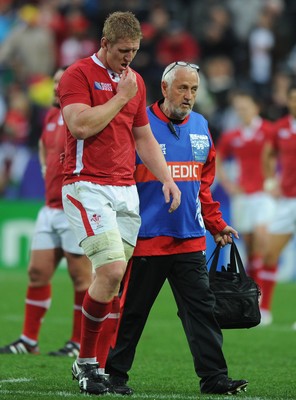 02.10.11 - Wales v Fiji - Rugby World Cup 2011 - Bradley Davies of Wales leaves the field with team doctor Prof John Williams. 