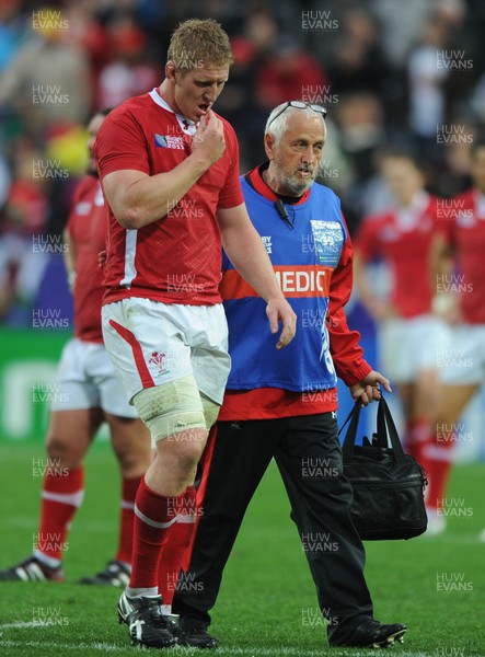 02.10.11 - Wales v Fiji - Rugby World Cup 2011 - Bradley Davies of Wales leaves the field with team doctor Prof John Williams. 